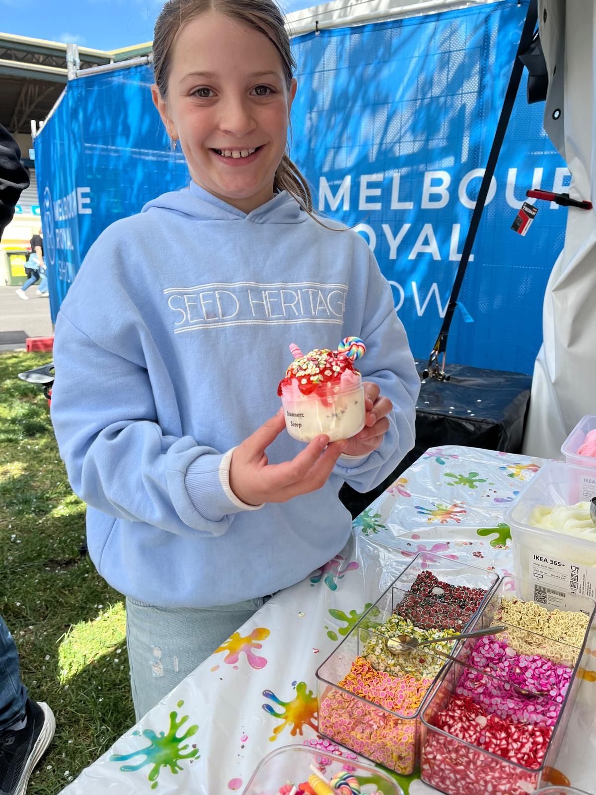 A customer showing her slime scoop at the sprinkle bar