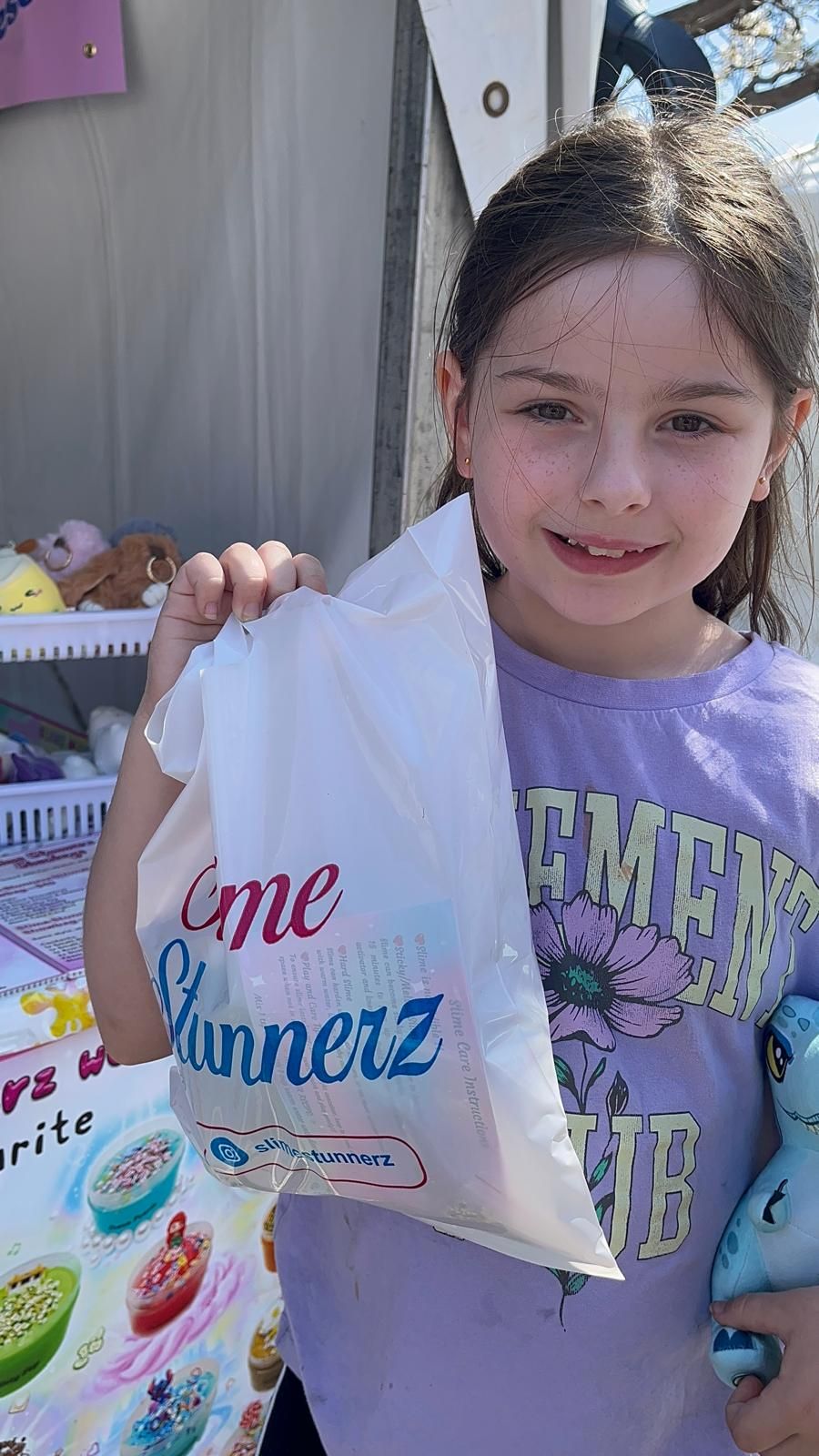 A happy customer holding her SlimeStunnerz showbag at the Melbourne Royal Show 2025
