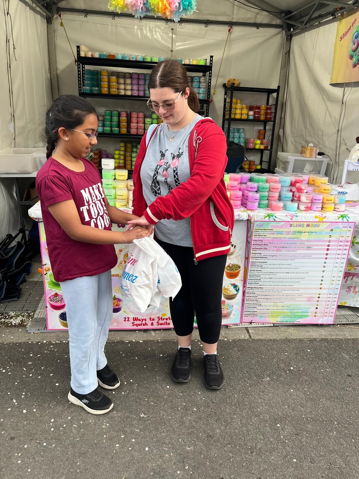 A customer collecting her showbag at the SlimeStunnerz stall